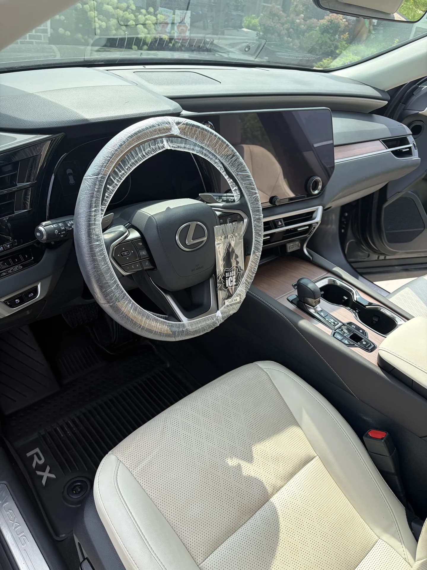 Lexus cabin with light leather seats and a detailed dashboard