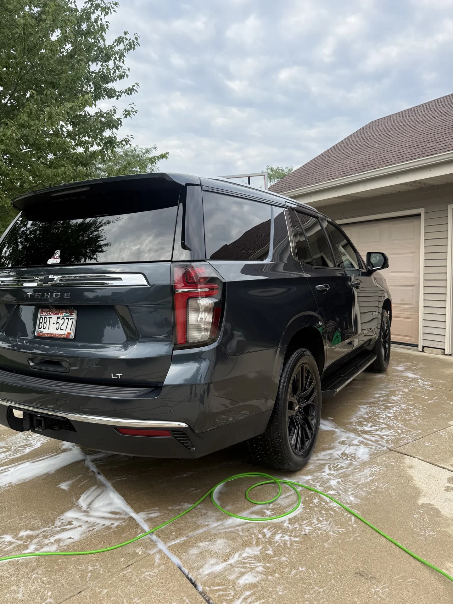 Dark SUV freshly washed in a residential driveway